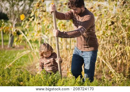 Father And Child Working In The Garden