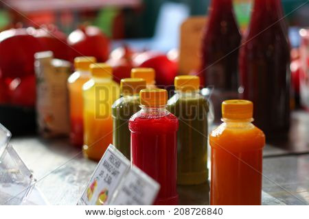 Homemade juice smoothie at market many bottles