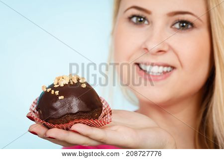 Woman Holding Chocolate Cupcake About To Bite