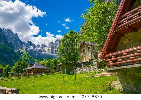 A Small Village Is Located Among The Snow-capped Mountains.