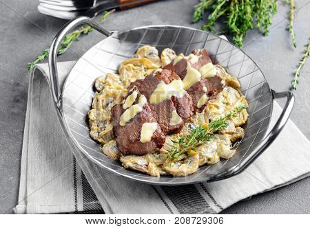 Dish with steak Diane on table
