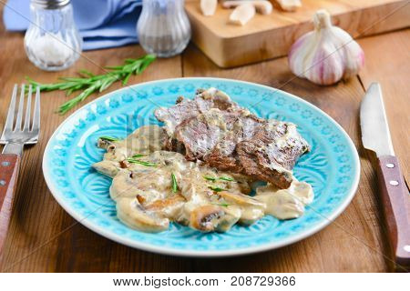 Plate with steak Diane on table