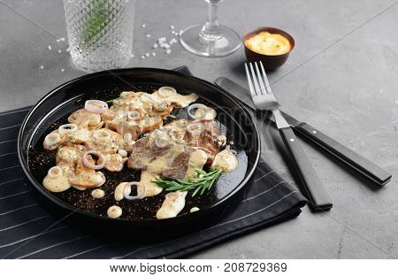Plate with steak Diane on table