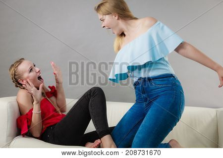 Two young pretty women being mad at each other having argue fight. Friendship rivaly and envy problems.