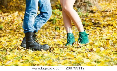 Fashion footwear dating romance love youth outdoor concept. Young lady meeting rough boy. Elegant girl in glamour shoes with man in jeans boots.