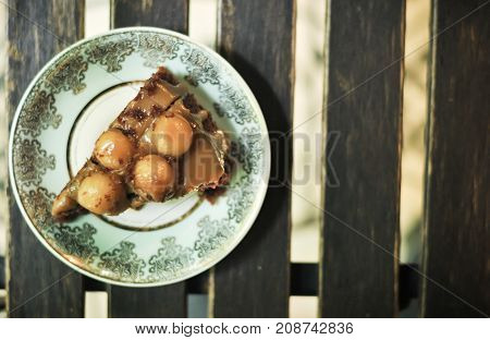 top view of a piece of sweet macademia cookies cake, delicious sweet dessert with beautiful dish