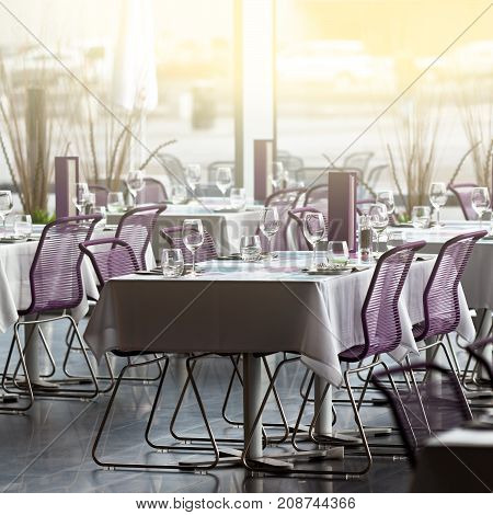 Indoor restaurant tables ready for service with a beautiful sunlught