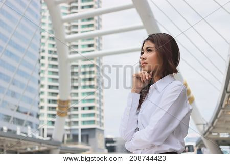 Portrait of confident young Asian businesswoman standing and looking far away in the city background.Leadership woman concept. Vintage color tone