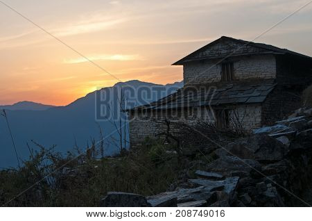 Silhouette Of Nepalese Traditional Brick House During Sunset In Kaski District, Annapurna Himal.