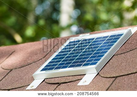 Small photovoltaic battery on bower roof alternative energy.