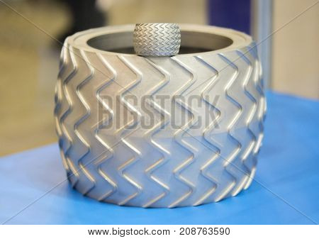 Object printed on metal 3d printer. A model created in a laser sintering machine close-up. DMLS SLM SLS technology. Concept of 4.0 industrial revolution. Progressive modern additive technology.