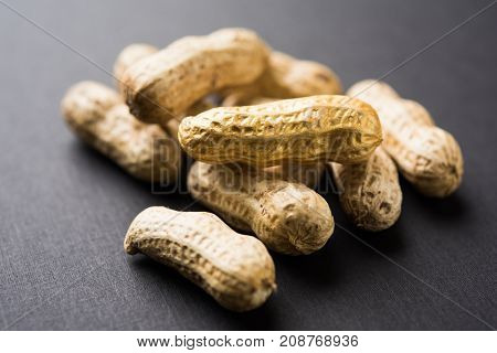 Concept of individuality, luck,value,exclusivity and better choice. Golden peanut or ground nut, standing out amongst normal peanuts, over black or white background
Concept of individuality, luck,value,exclusivity and better choice. Golden peanut or groun