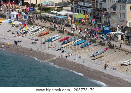 ETRETAT, FRANCE - AUGUST 25, 2017: Aerial view beach and promenade with tourists and seaside visitors of Etretat in Normandy, France