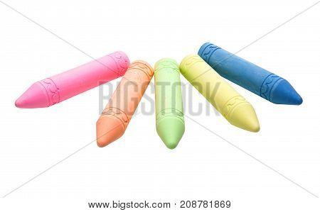 Sticks of pastel colored chalk casting shadow on white background.