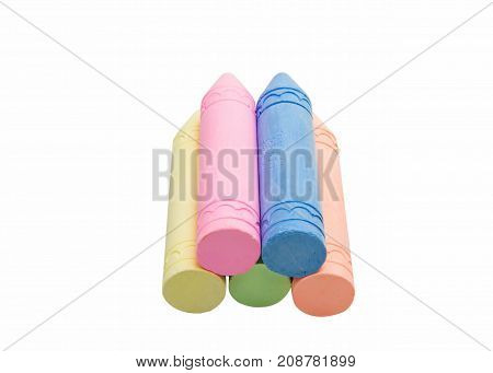 Sticks of pastel colored chalk casting shadow on white background.