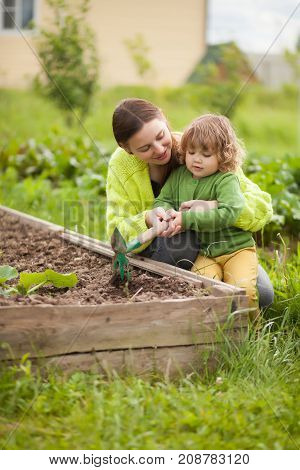 Mother And Daughter Working In The Domectic Garden