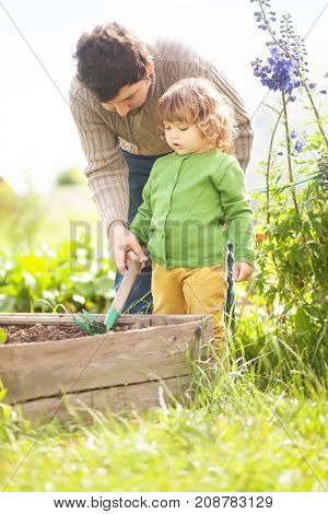 Father And Daughter Working Together In The Garden