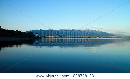 View on level water in dam Liptovska Mara with the background of the Havranok church. Water reservoir on Liptov.