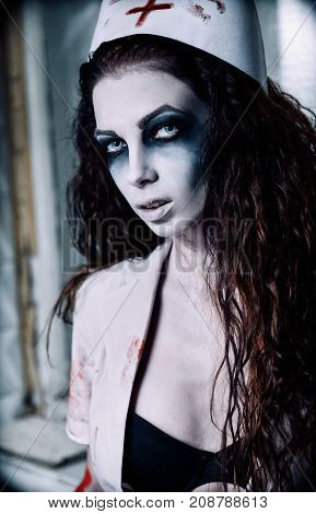 Horror shot: portrait of the undead nurse (doctor). Zombie woman (living dead)