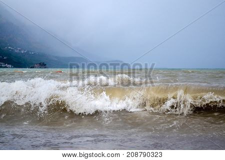 Powerful waves on the Adriatic coast. Dirty wave. Dark sky. The storm is approaching