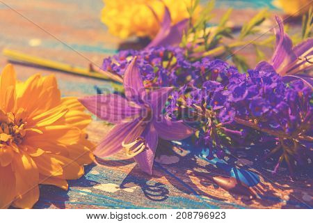 multicolor flowers on the abstract wooden background