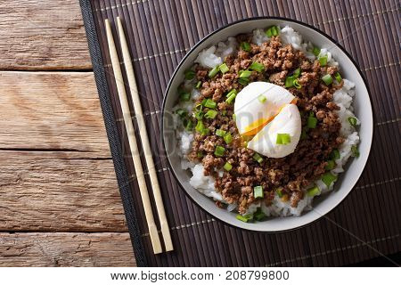 Japanese Spicy Beef Soboro With Egg Benedict, Rice And Green Onion Close-up. Horizontal Top View