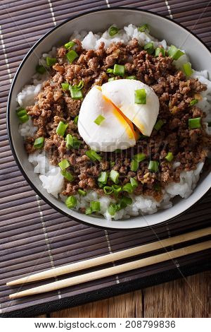 Japanese Dish: Spicy Meat Soboro With Egg Poached And Rice Close-up In A Bowl.vertical Top View