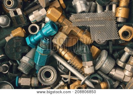 Industrial photo. Old vintage rusty and metal fittings iron and steel screw. Bolts hardware collection background. Assorted collection of used nuts and bolts
