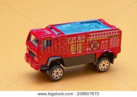 Red toy fire truck Toy fire engine extinguishes flaming house. Careless handling of fire dangerous for life