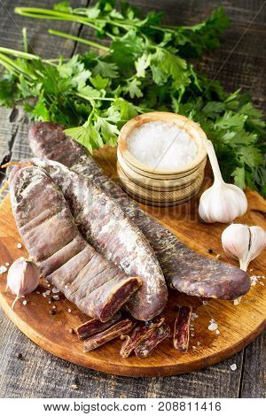 Beef Jerky Smoked Sausage Sudzhuk With Spices And Garlic Is Served On A Cutting Board. Copy Space Fo