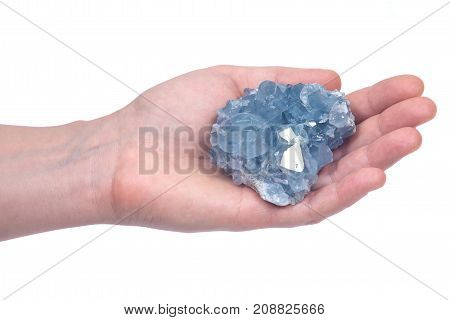 Woman's hand holding blue celestite cluster isolated on white background