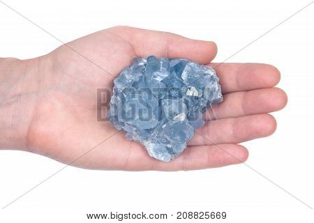 Woman's hand holding blue celestite cluster isolated on white background