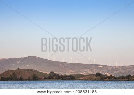 Romanian Wind Farm with Wind Turbines and windmills facing the Danube river in the Iron Gates valley. Due to the heavy winds in the gorges it has been chosen as a spot to develop green energies