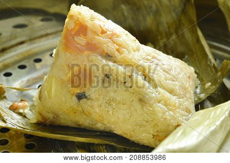 sticky rice steam with pork and salt egg wrapped in banana leaf of Chinese Duanwu festival on pot