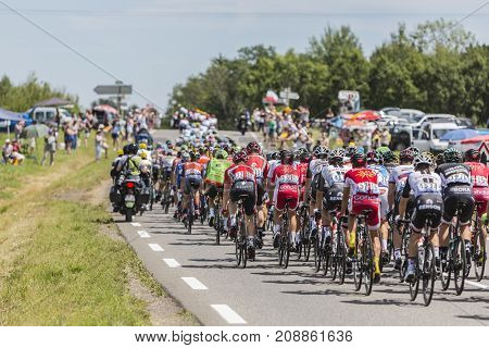 Mailleroncourt-Saint-Pancras France - July 5 2017: The rear view of the peloton riding on a road to La Planche des Belle Filles during the stage 5 of Tour de France 2017.