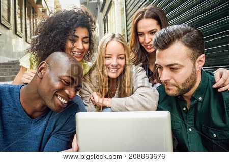 Multi-ethnic Group Of Young People Looking At A Tablet Computer