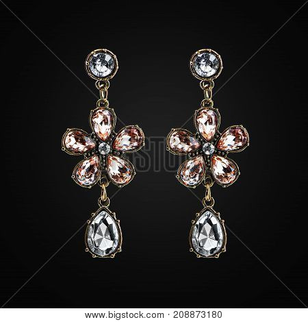 Gold earrings with jewels isolated on the black