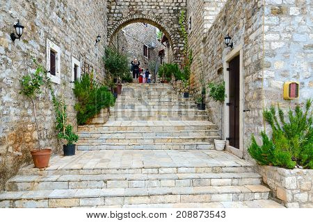 ULCINJ MONTENEGRO - SEPTEMBER 9 2017: Unknown tourists photograph urban view on street of Old Town Ulcinj Montenegro