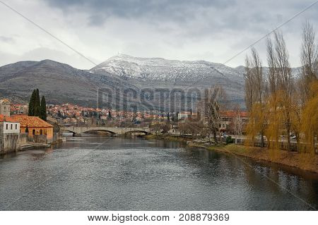 Trebisnjica river near Old Town of Trebinje on a cloudy winter day. Bosnia and Herzegovina