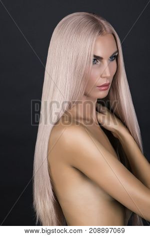 Doll looking model. Long cold pink smooth hair. Posing in studio nacked.