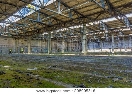 Abandoned large factory industrial interior. Inside the ruins of an old factory in Romania of a Communist Era. Step inside of abandoned old factory in eastern Europe.