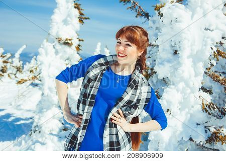 the woman standing in the winter in the mountains, happy in the snow