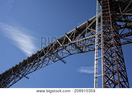 A view of the Poughkeepsie Bridge known as the Walkway Over the Hudson details the bridge architecture and includes the shaft of the glass elevator that takes visitors to the top.