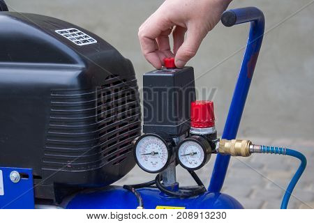 Starting the air compressor with your hand in the yard