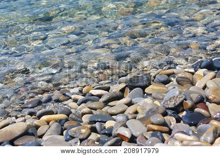 Amazing sea pebbles under water on the beach