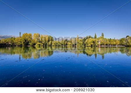 Autumn colors and reflection on Puigcerda's pond in Pyrenees. Located in north Catalonia, Spain.