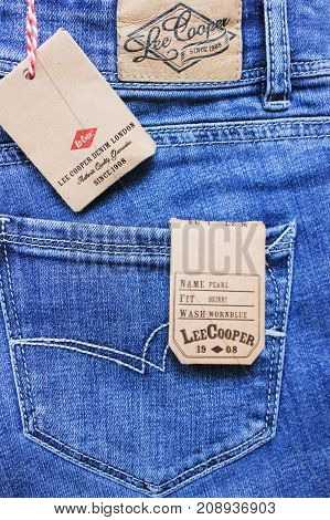 MOSCOW, RUSSIA - OCTOBER 8, 2017: Lee Cooper Denim Jeans with Tags. English clothing company established in 1908 operating worldwide. Blue textured jean material with brand new labels close up image