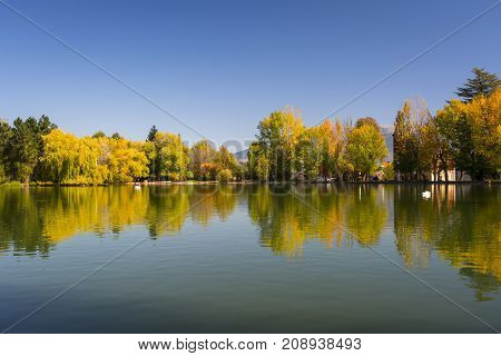 Autumn colors and reflection on Puigcerda's pond in Pyrenees. Located in north Catalonia, Spain.