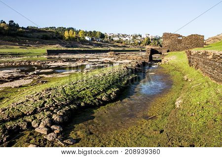 Ruins on the bottom of a dry reservoir in Portomarin Northern Spain.