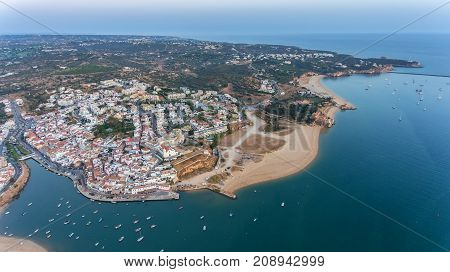 Aerial. Ferragudo at sunset shooting from the sky with drone.